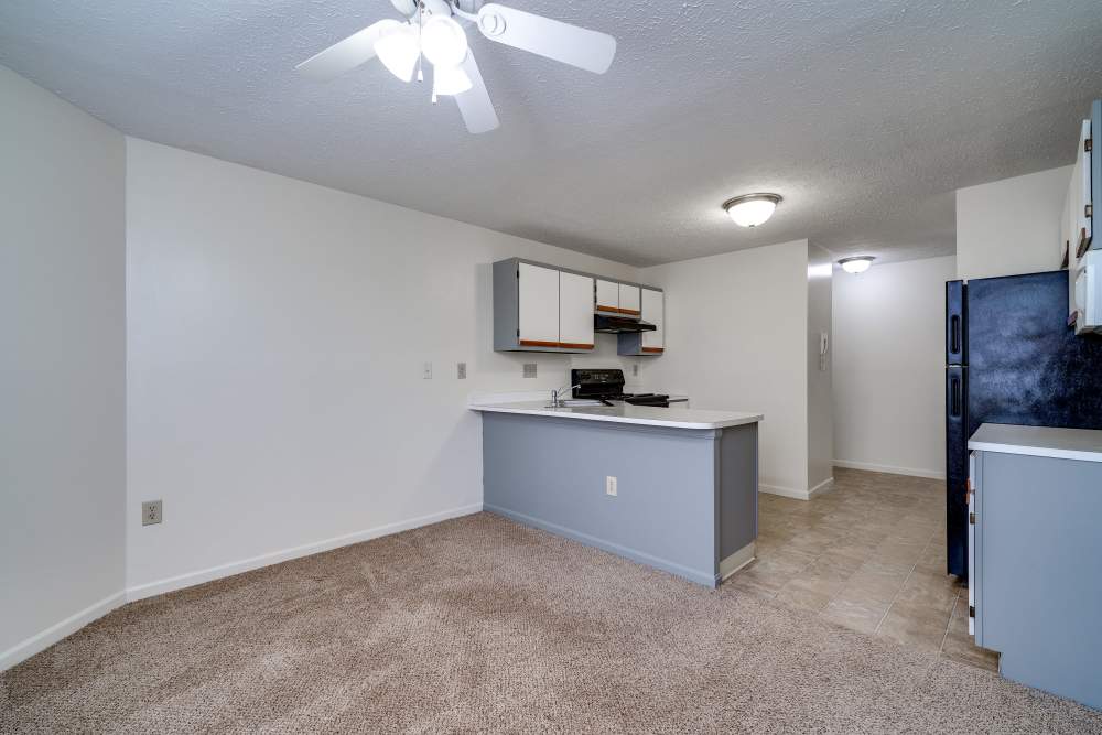 Apartment living room with breakfast bar and kitchen at Carriage Court in Cincinnati, Ohio