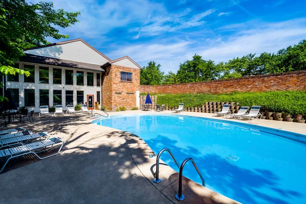 Outdoor swimming pool with lounge seating at Carriage Court in Cincinnati, Ohio