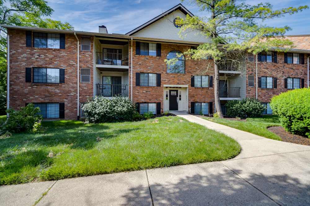 Brick apartment building with landscaped grounds at Carriage Court in Cincinnati, Ohio
