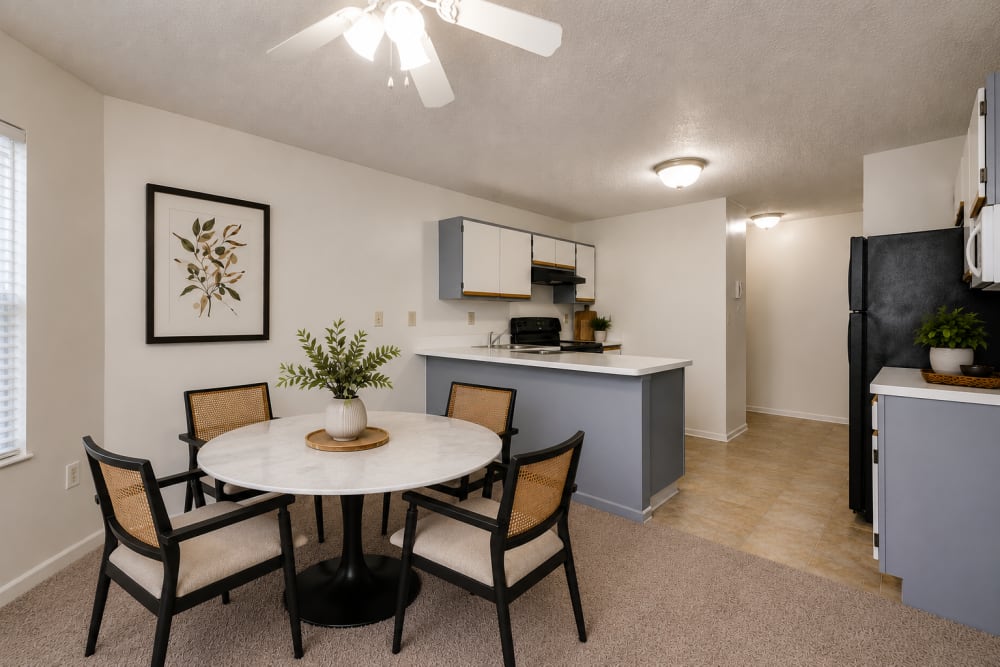 Staged dining area with breakfast bar and kitchen at Carriage Court in Cincinnati, Ohio