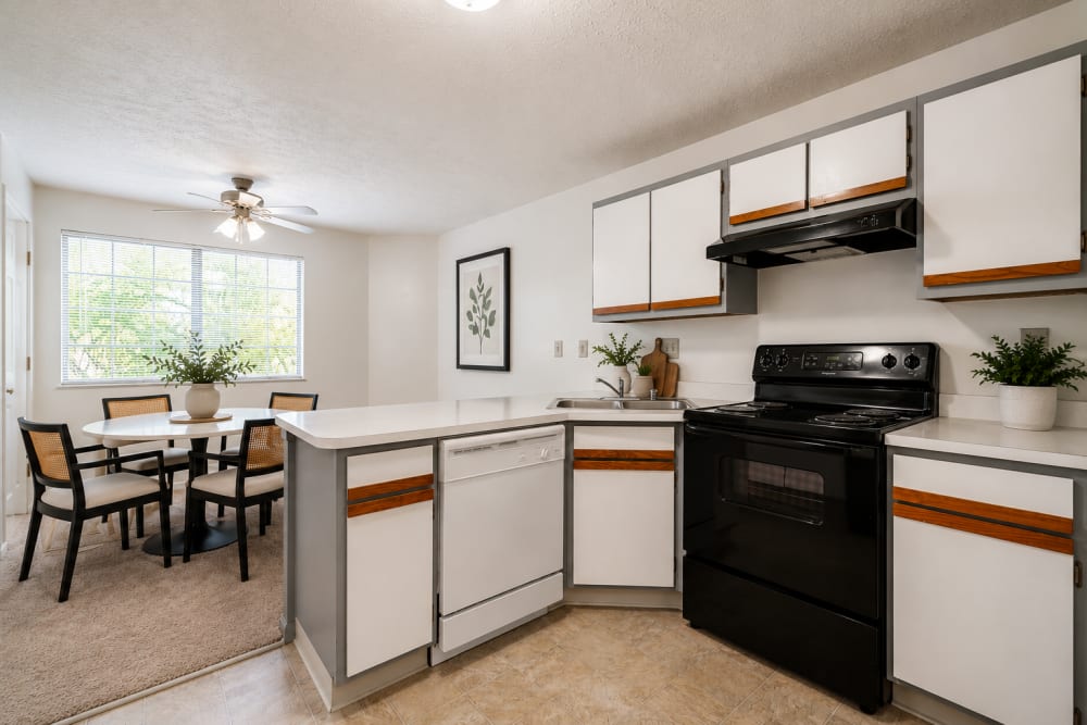 Staged dining area with breakfast bar and kitchen at Carriage Court in Cincinnati, Ohio