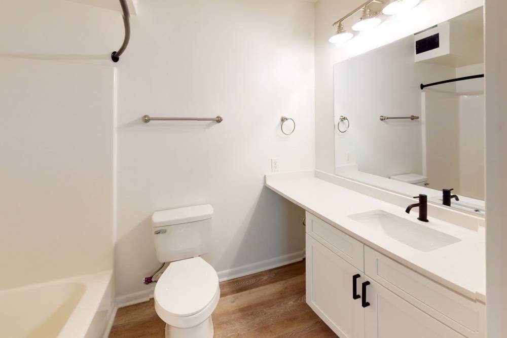 Bathroom with frameless vanity mirror at Wallace Terrace Apartments in Charlotte, North Carolina 