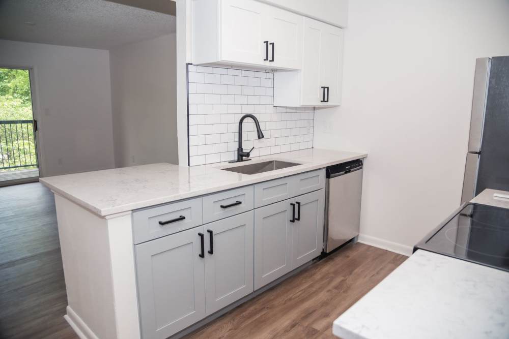 Kitchen with grey color cabinet  at Wallace Terrace Apartments in Charlotte, North Carolina