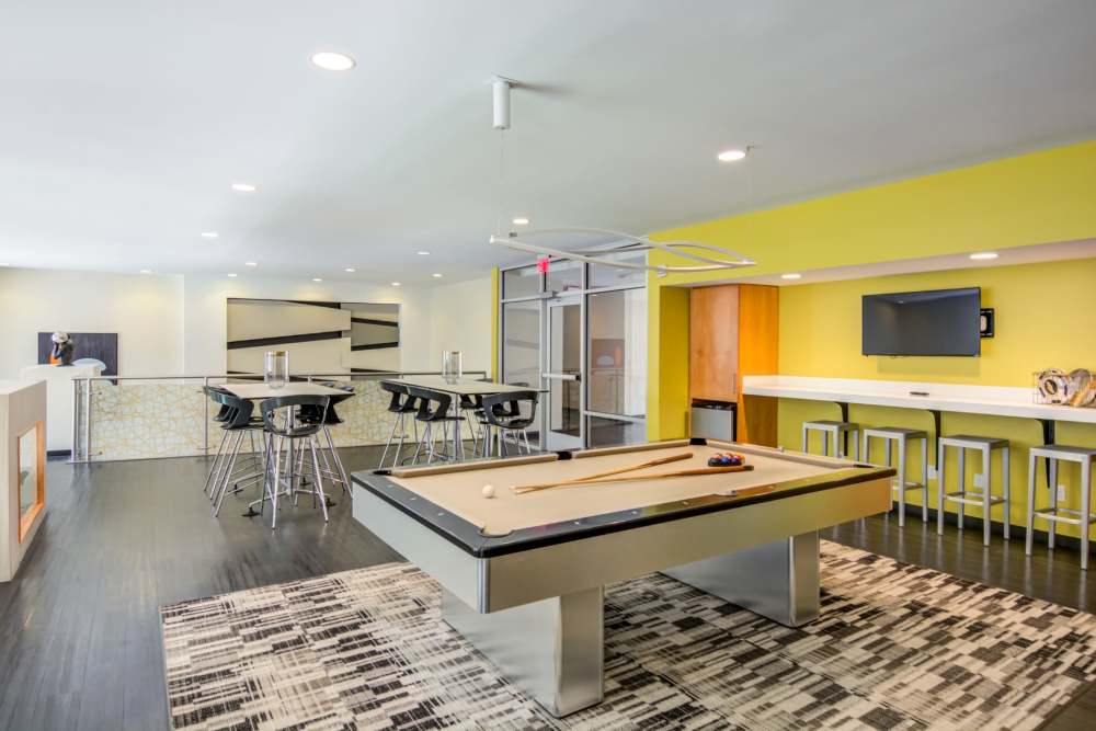 Yellow accent wall with seating area at The Residences at Town Center in Virginia Beach, Virginia