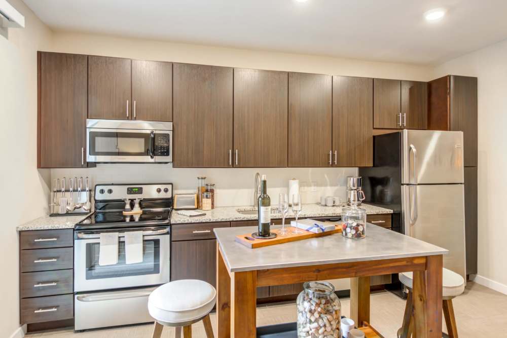 Kitchen with dark cabinets and stainless appliances at The Residences at Town Center in Virginia Beach, Virginia