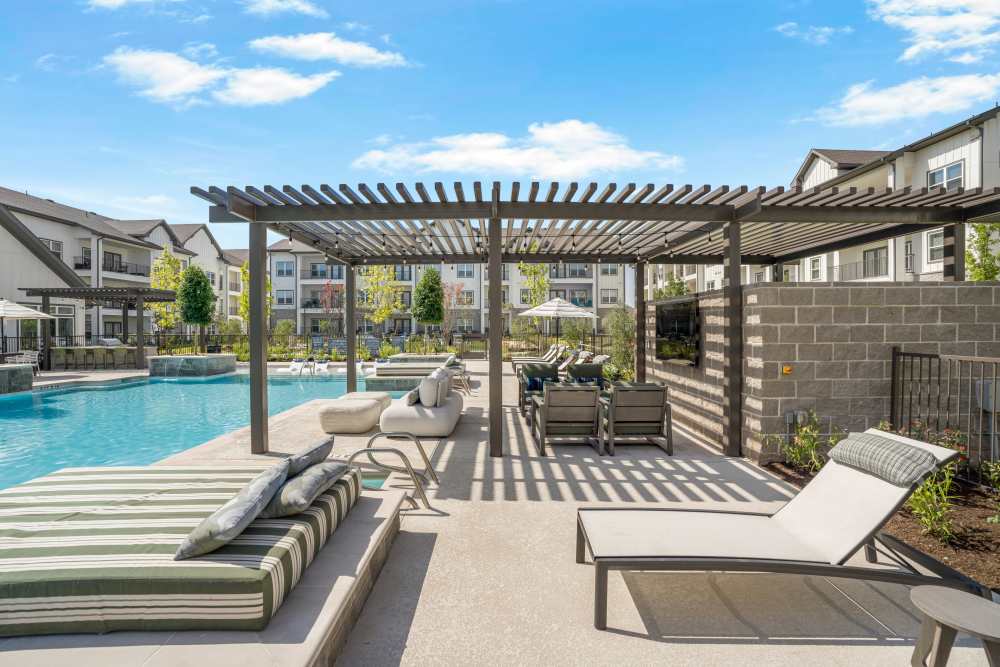 Resort-style swimming pool with lounge chairs and sun deck.
