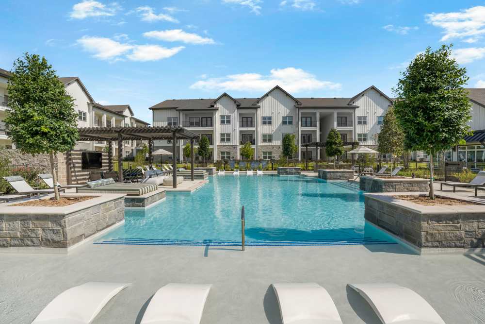 Swimming pool with sun loungers.
