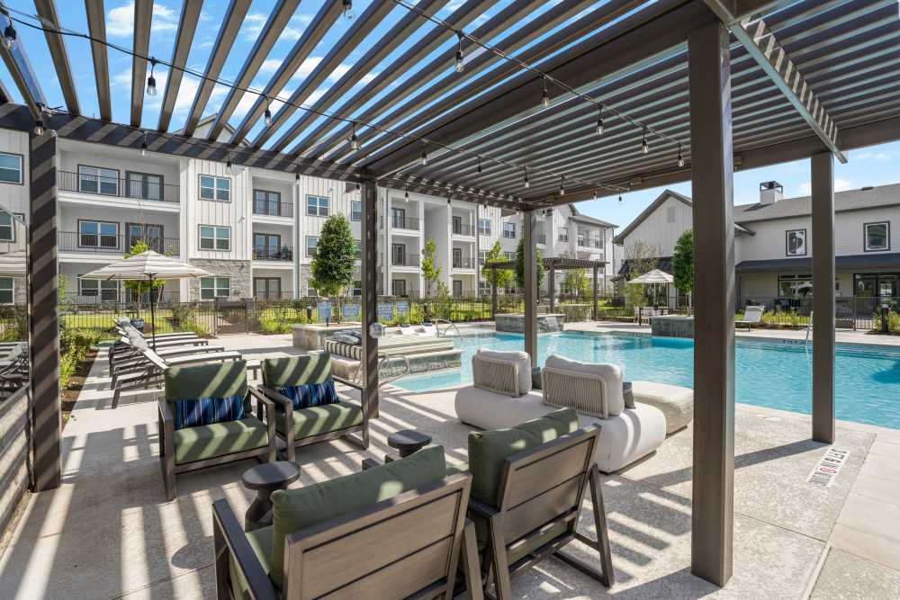Pergola-shaded seating adjacent to the pool.