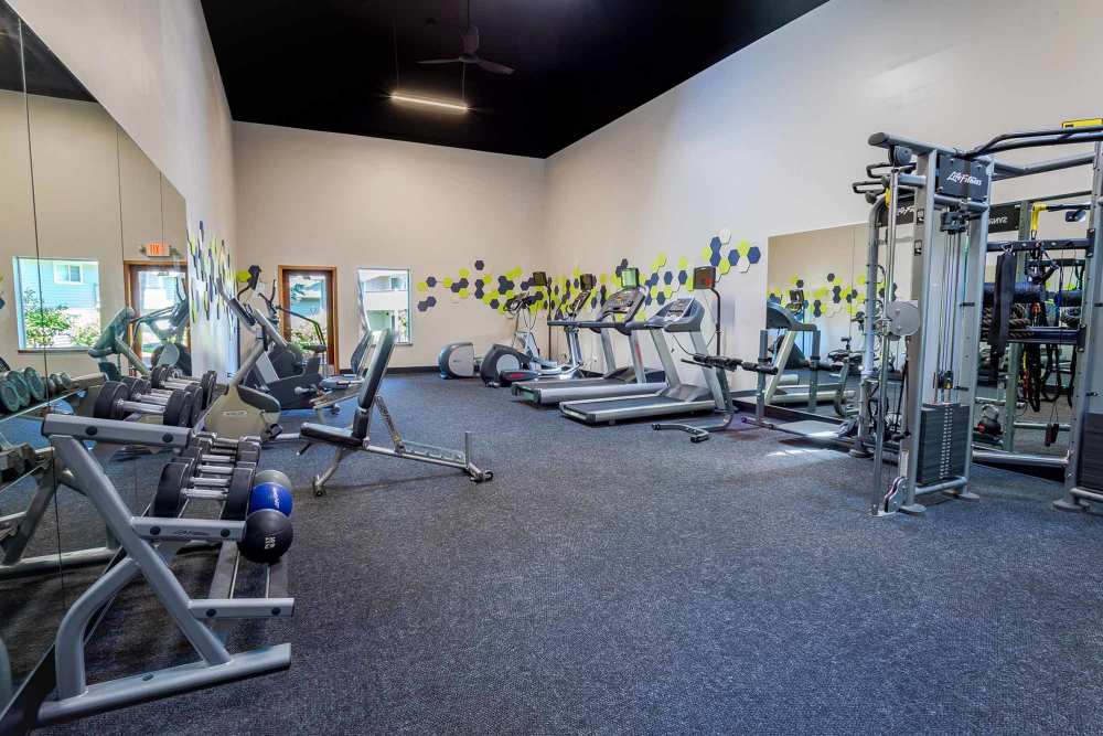 Modern fitness center with plenty of equipment at The Park at Cooper Point Apartments in Olympia, Washington
