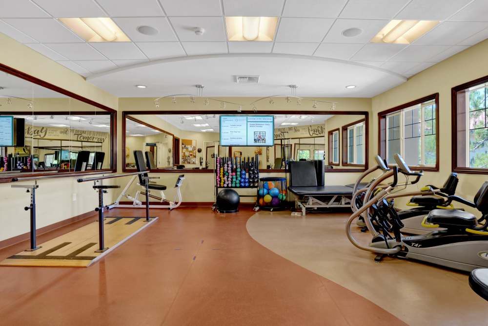 Fitness center with cardio equipment and therapy station at Estancia Del Sol in Corona, California