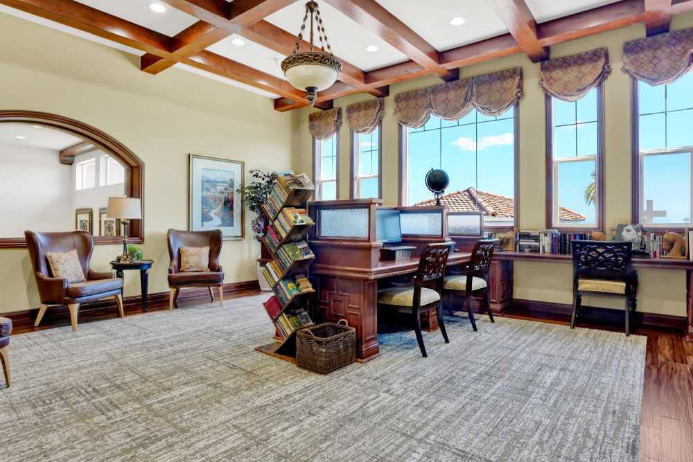 Library and reading lounge with computers and bookshelves at Estancia Del Sol in Corona, California