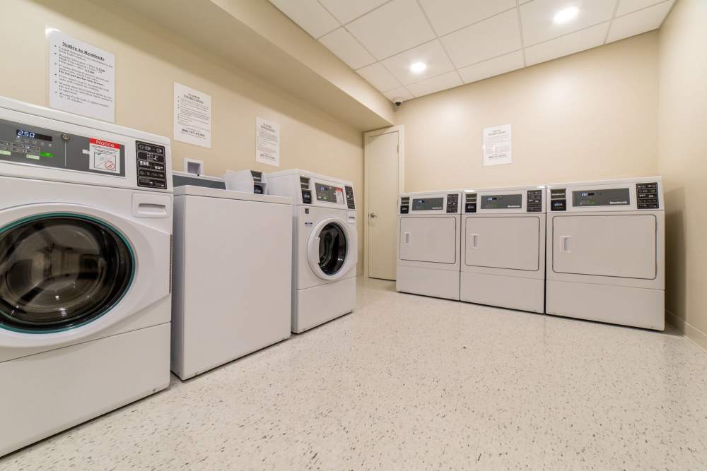 Laundry room with modern washers and dryers at The Charlestown in Charlestown, Massachusetts