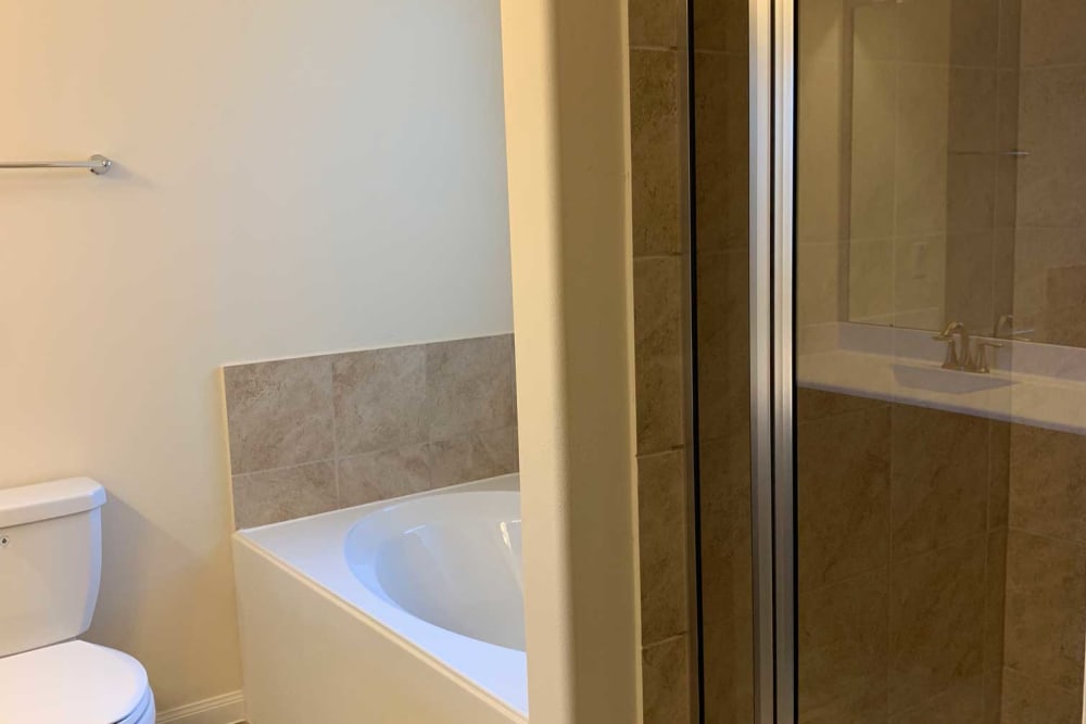 Bathtub and shower in bathroom at 36 Palms Townhomes in Missouri City, Texas
