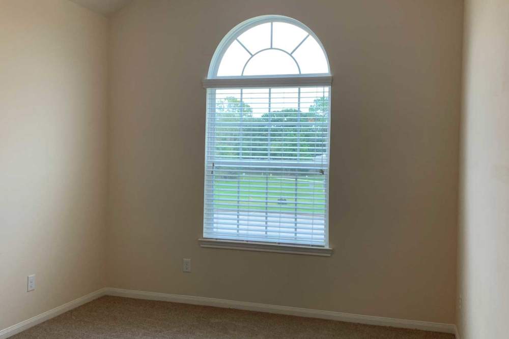 Window with blinds and arched top at 36 Palms Townhomes in Missouri City, Texas