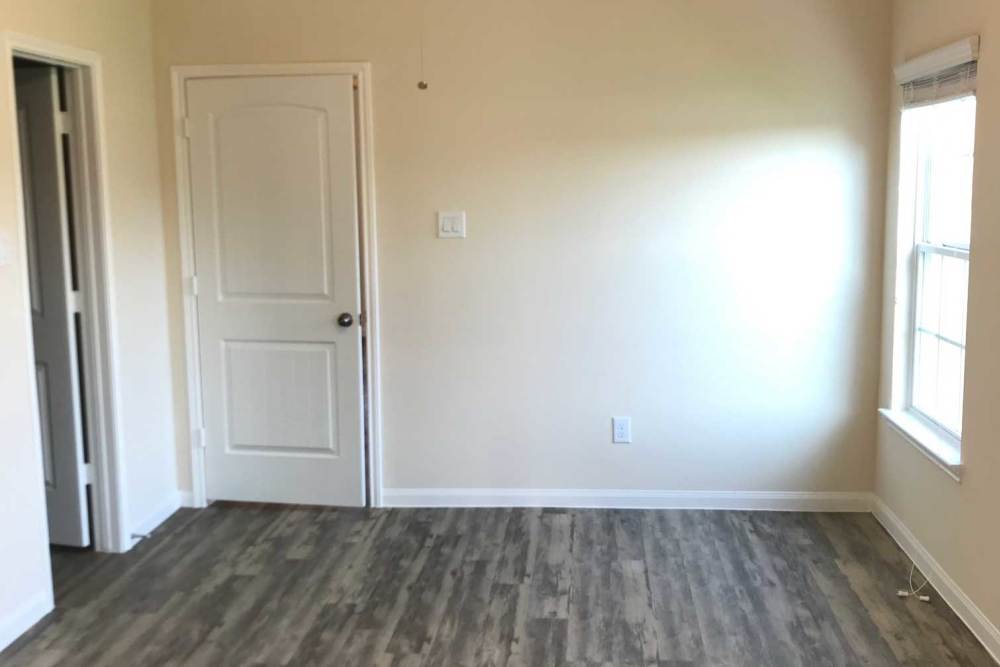 Empty room with light-colored walls and window at 36 Palms Townhomes in Missouri City, Texas