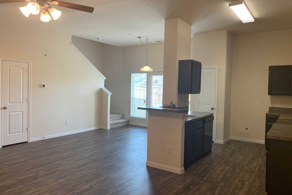 Ceiling fan spins in open living area at 36 Palms Townhomes in Missouri City, Texas