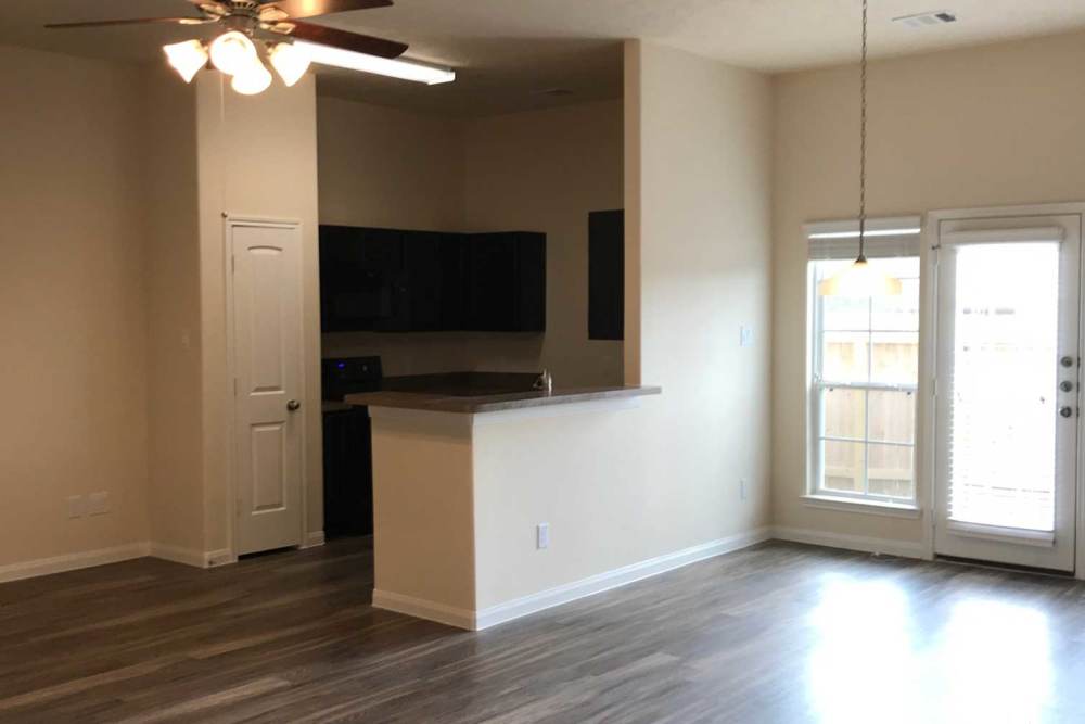 Light wood flooring with a ceiling fan at 36 Palms Townhomes in Missouri City, Texas