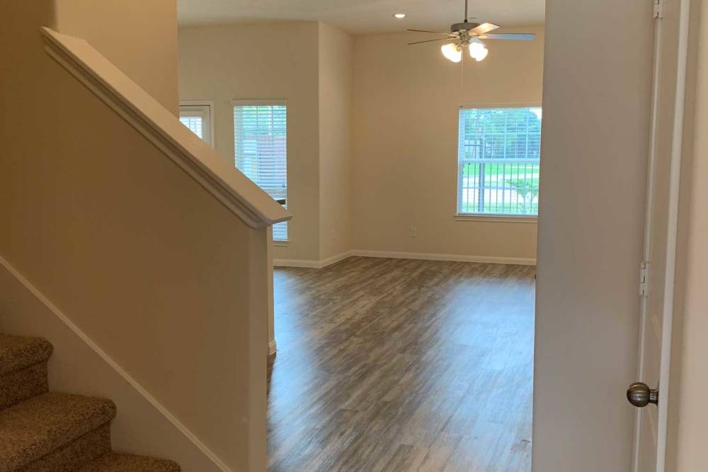 Stairs lead to a room with windows at 36 Palms Townhomes in Missouri City, Texas