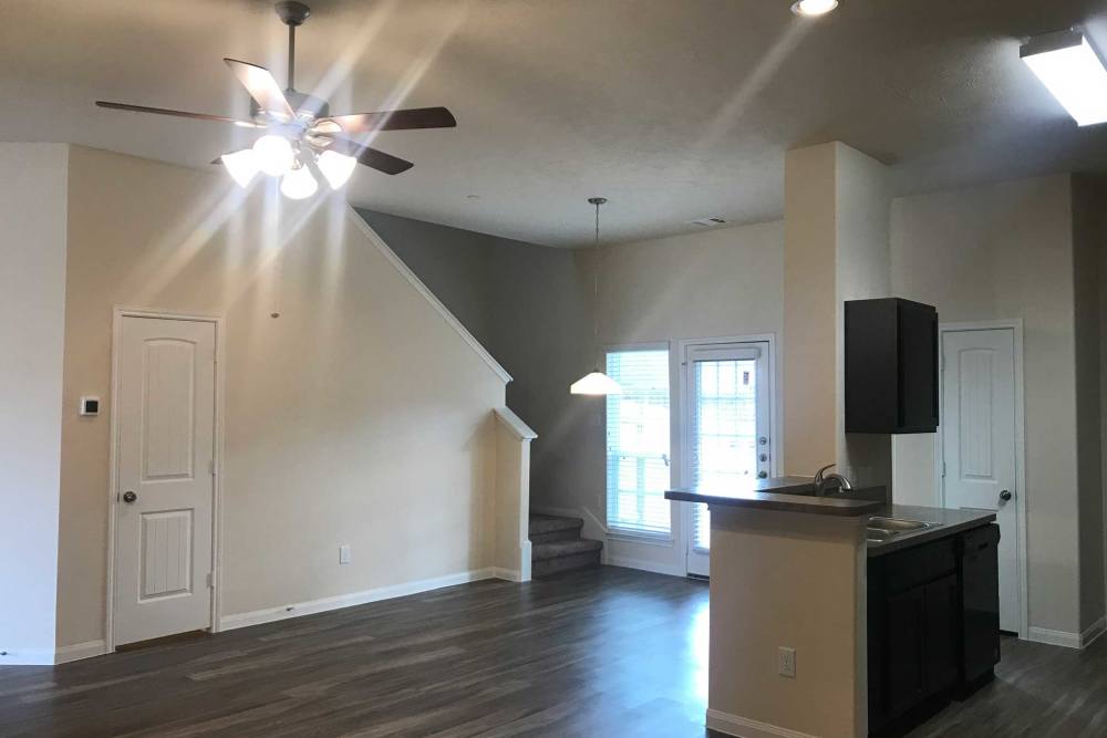 Light wood flooring and ceiling fan at 36 Palms Townhomes in Missouri City, Texas