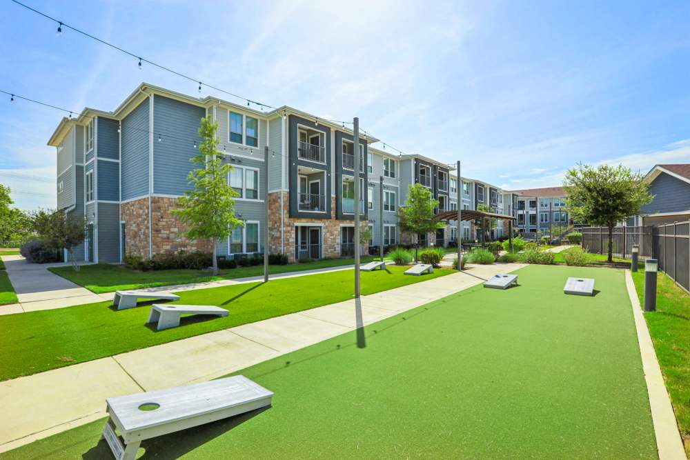 Modern apartment buildings surrounding landscaped courtyard area Limestone Ridge Apartments in Austin, Texas