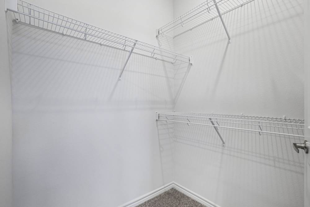 Walk-in closet with built-in shelving and hanging space Limestone Ridge Apartments in Austin, Texas