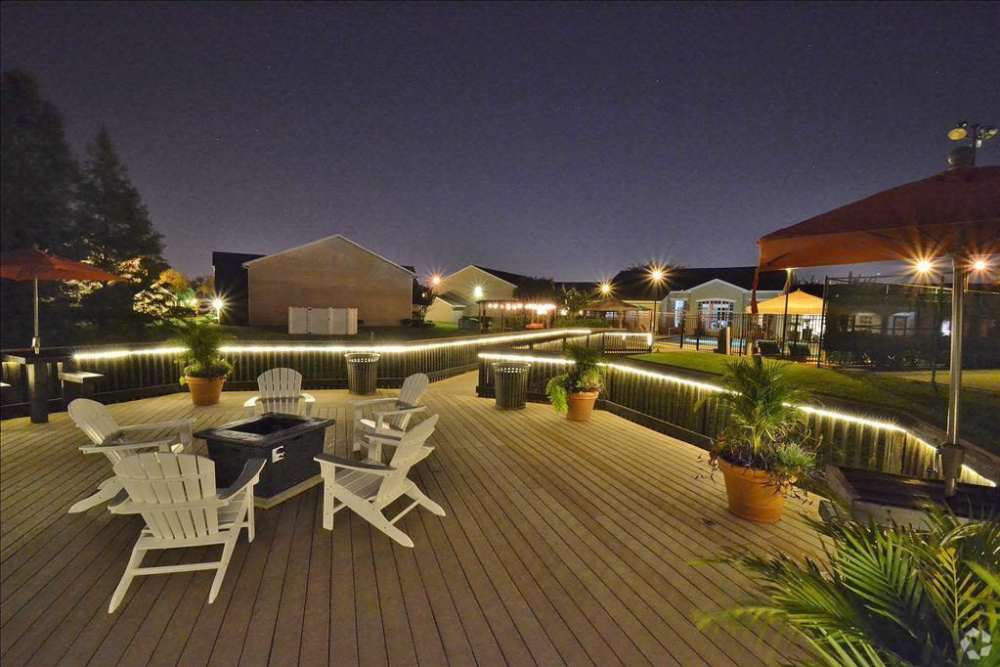 Outdoor seating area with fire pit at night at Highpoint Club in Orlando, Florida