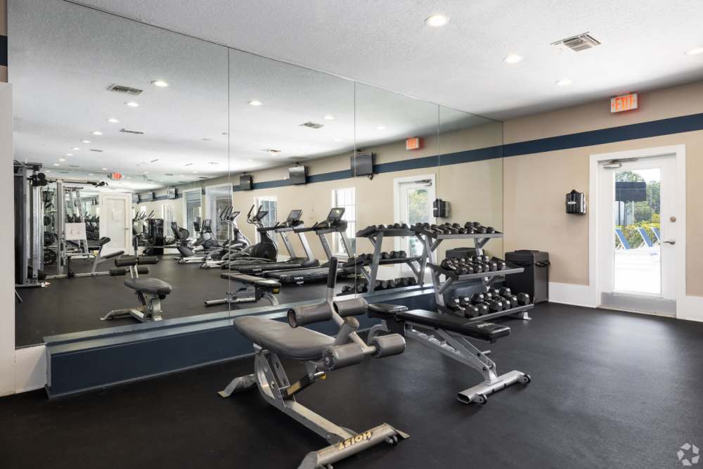 Bright fitness center with cardio machines at Highpoint Club in Orlando, Florida