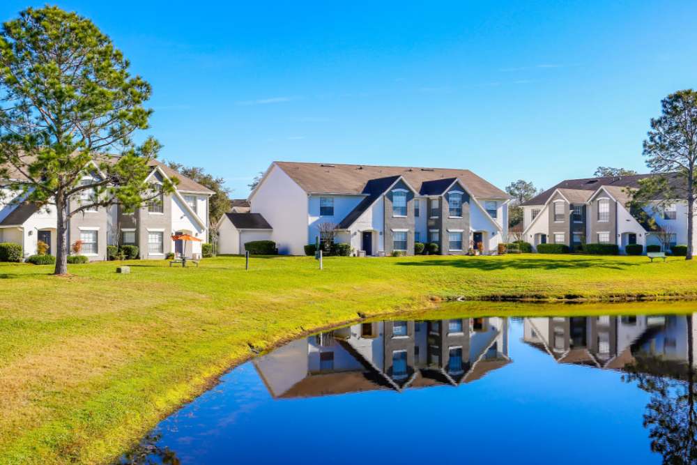 Pond reflecting apartment buildings near Highpoint Club in Orlando, Florida