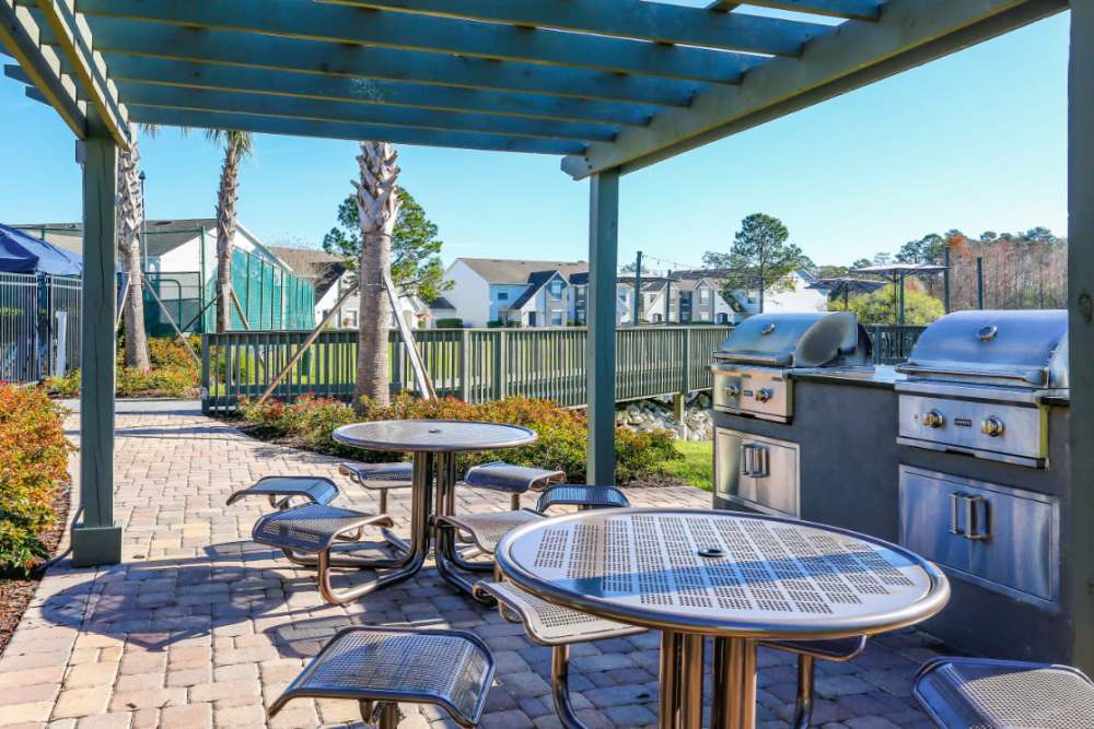 Outdoor grilling area with tables at Highpoint Club in Orlando, Florida