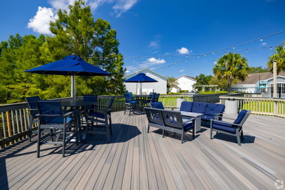 Relaxing outdoor seating area with umbrellas at Highpoint Club in Orlando, Florida