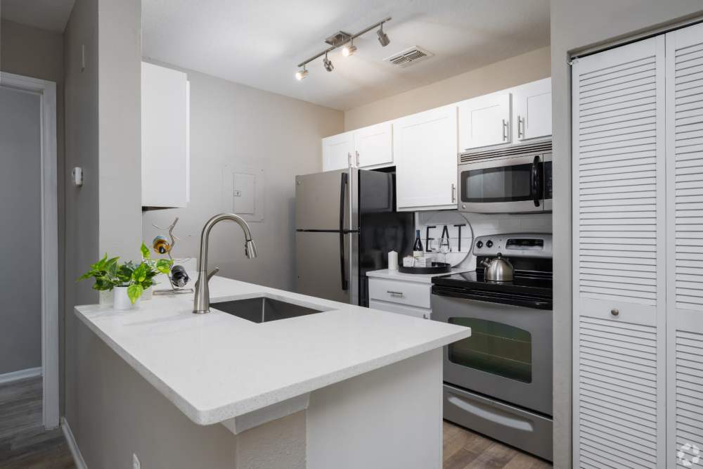 Modern kitchen with stainless steel appliances at Highpoint Club in Orlando, Florida