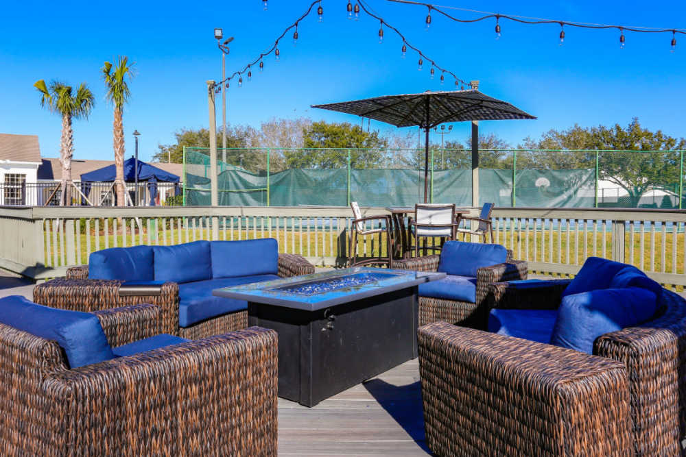 Fire pit seating area with lounge chairs at Highpoint Club in Orlando, Florida