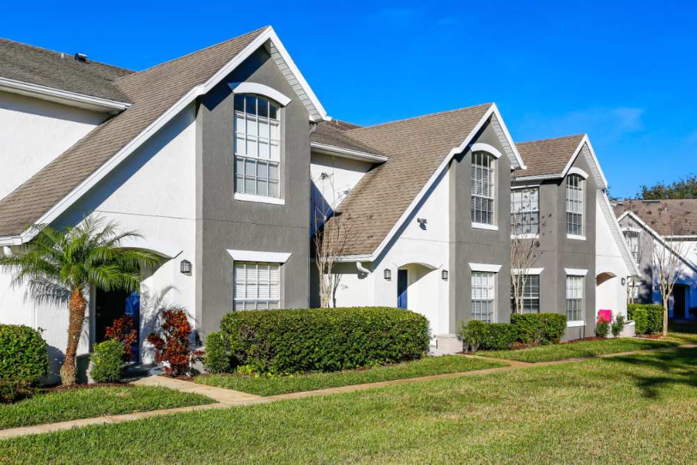 Lush greenery lining charming apartment exteriors at Highpoint Club in Orlando, Florida