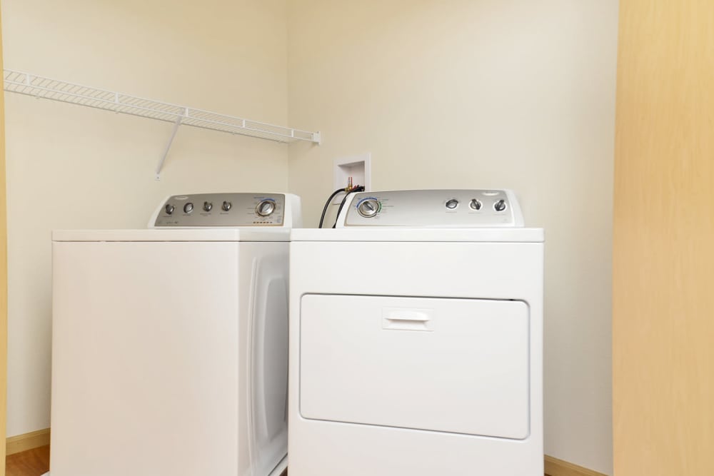 Laundry room with white washer and dryer at Longfellow Station in Minneapolis, Minnesota