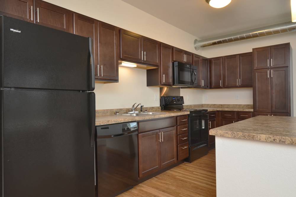 Modern kitchen with dark wood cabinets at Longfellow Station in Minneapolis, Minnesota