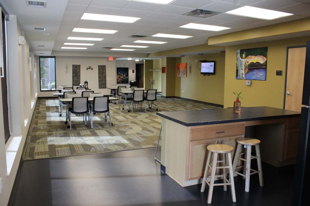 Spacious community room with seating and modern decor at Longfellow Station in Minneapolis, Minnesota