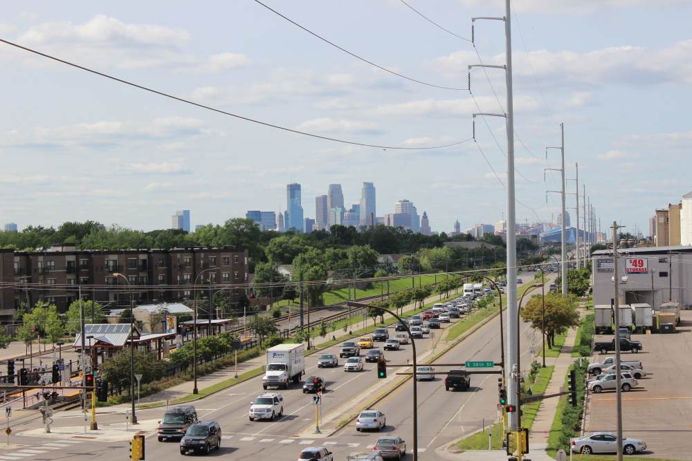 City skyline view with busy road and greenery along the street at Longfellow Station in Minneapolis, Minnesota