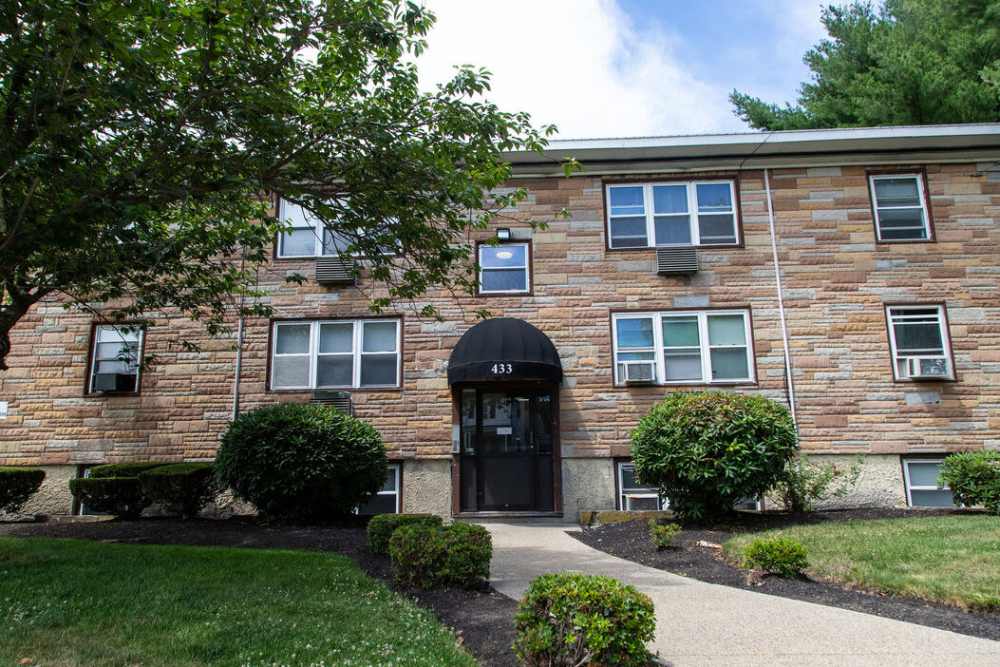Apartment building exterior with landscaped entry at Westfield Condominium in Brockton, Massachusetts