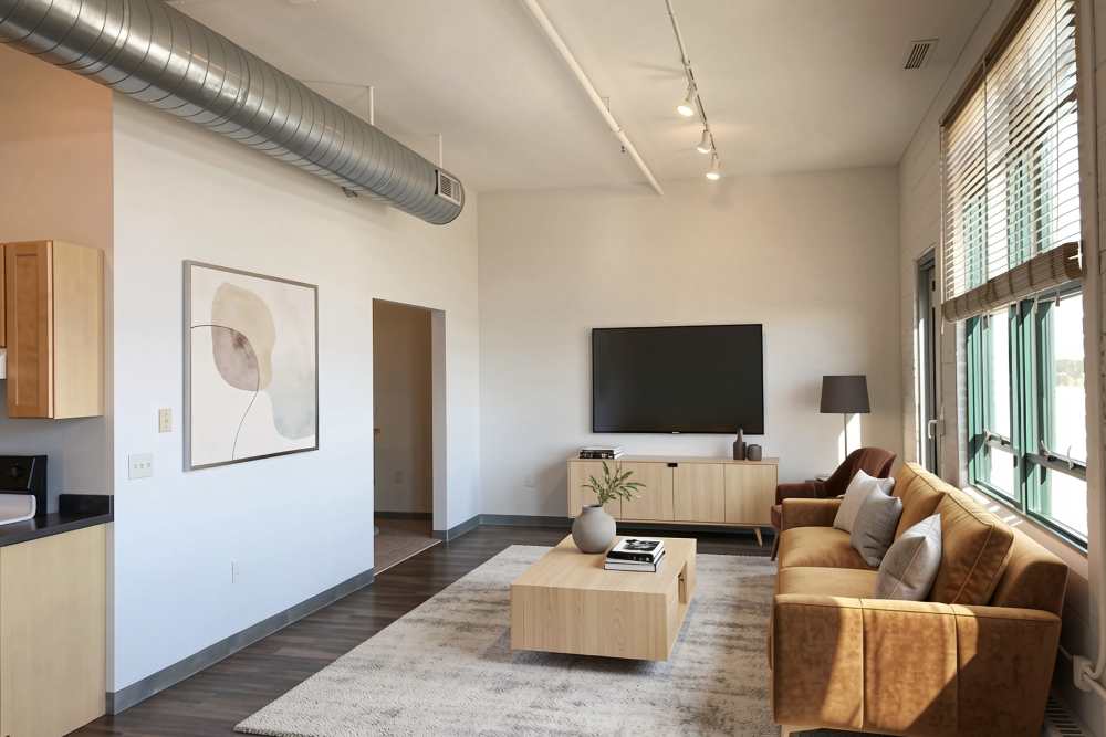 Virtually staged living area with couch, table, and tv