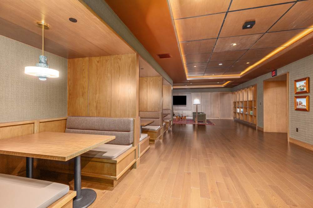 Modern community lounge with booth seating and open gathering area at Residences at 111 Lyon in Grand Rapids, Michigan
