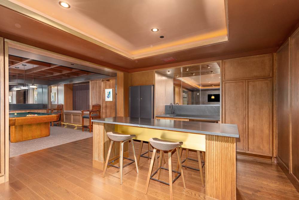 Community kitchenette with bar seating and nearby game room at Residences at 111 Lyon in Grand Rapids, Michigan