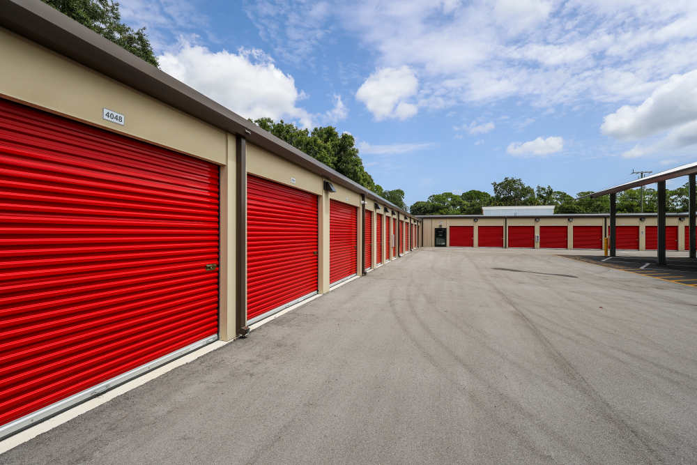 Outdoor self-storage units with bright red roll-up doors at Your Storage Units Vero Beach in Vero Beach, Florida