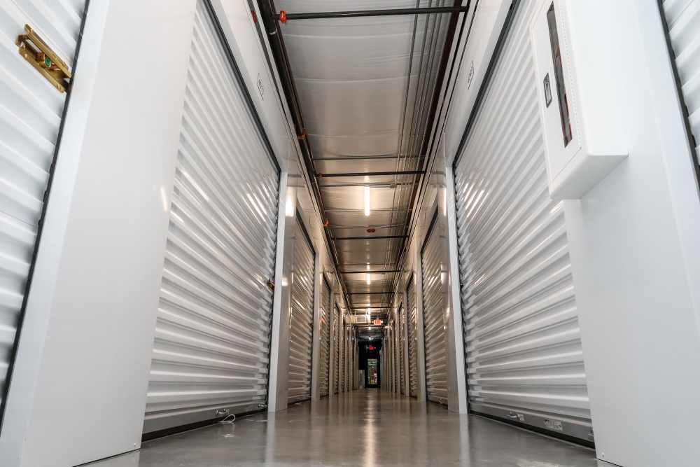 Indoor self-storage hallway with secure roll-up unit doors at Your Storage Units Bunnell in Bunnell, Florida