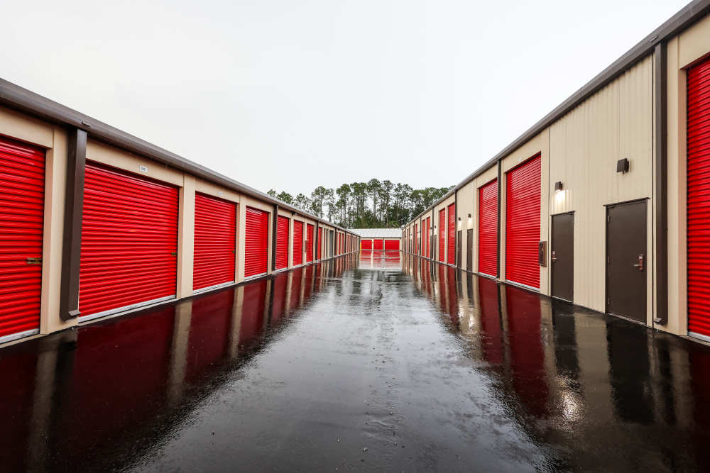 Drive-up self-storage units with red roll-up doors at Your Storage Units Bunnell in Bunnell, Florida