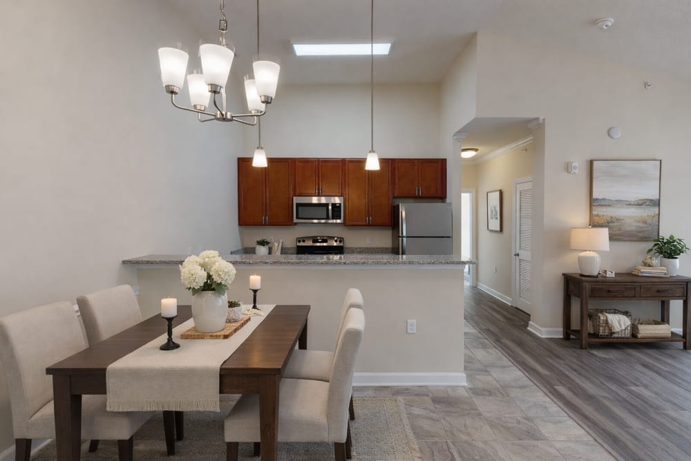 Furnished dining room leading to the kitchen and living room at Palisades of Wake Forest in Wake Forest, North Carolina