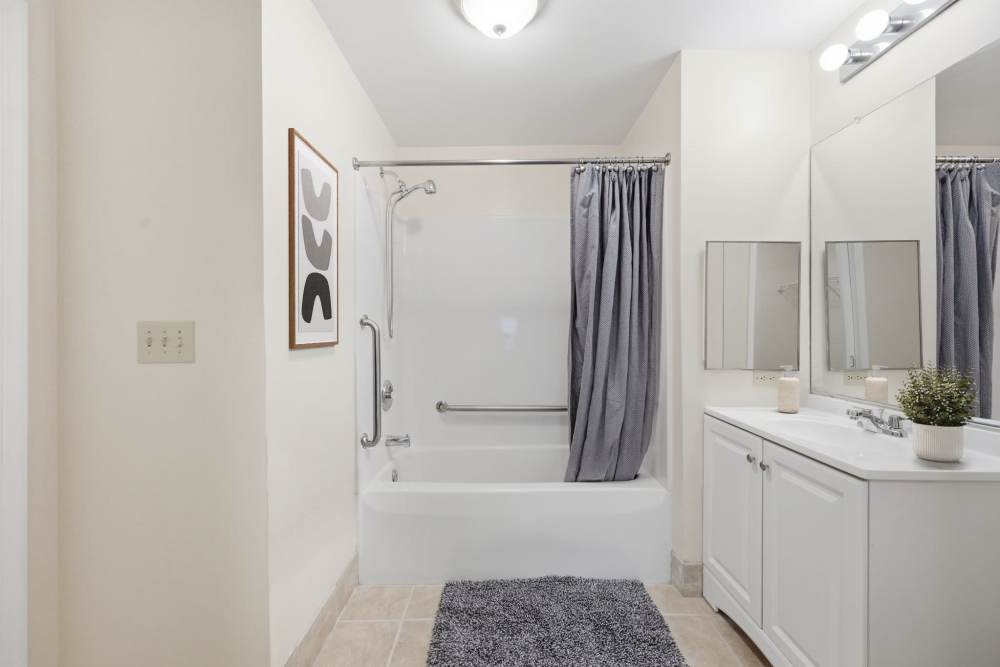 Bathroom with tub and white cabinet at Waverly Gardens in Woodstock, Maryland