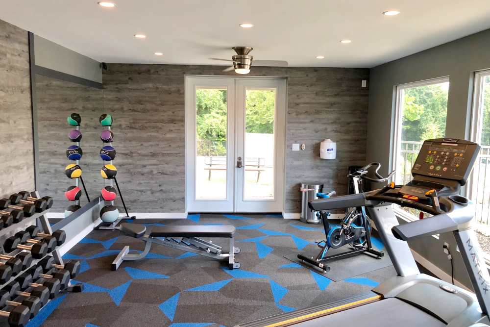 Weights and exercise equipment in gym at Collins Crossing Apartments in Carrboro, North Carolina