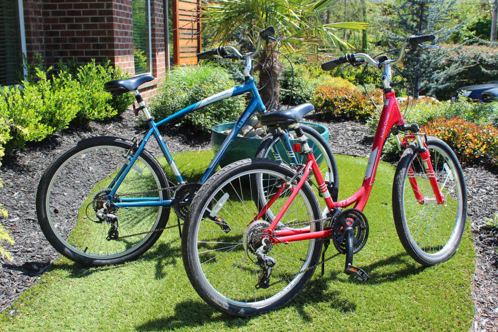 Two bicycles on green grass at Collins Crossing Apartments in Carrboro, North Carolina