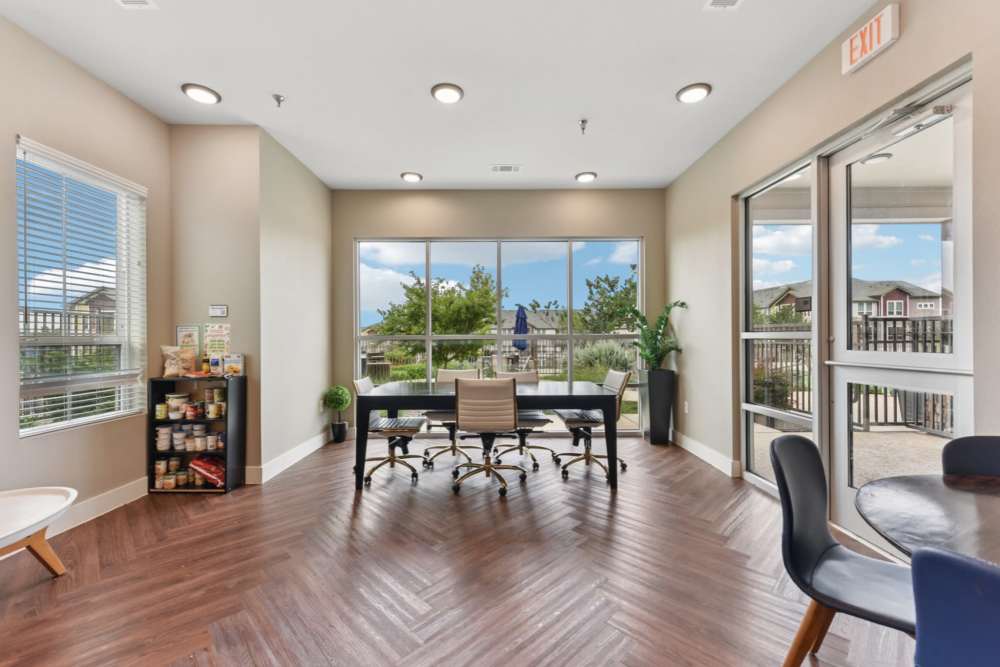Spacious resident lounge with fireplace and contemporary furnishings at McKinney Falls Apartments in Austin, Texas