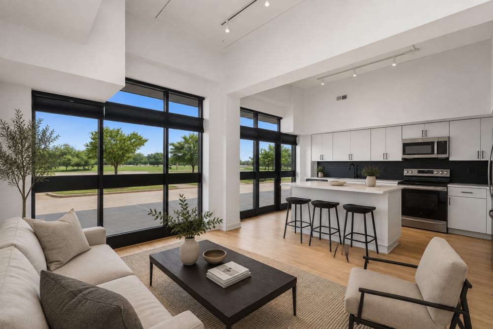 Bright living area with large windows at The Franklin in Ankeny, Iowa